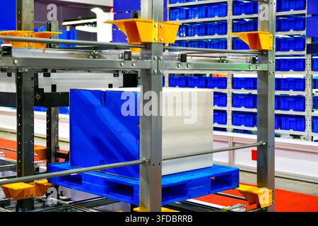 Industrial cardboard box package stored on automated racking system in smart logistics warehouse Stock Photo