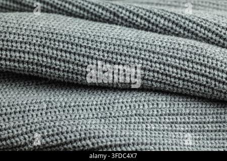Grey knitted wool fabric showcasing soft texture and cozy weave pattern Stock Photo