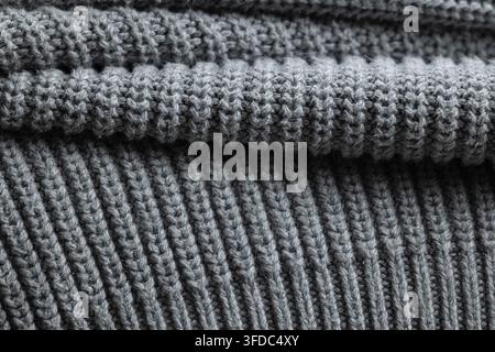 Grey knitted wool fabric showing a soft textured surface with ribbed pattern Stock Photo