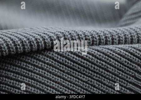Grey knitted wool fabric detail showing textured pattern, softness, and comfort Stock Photo