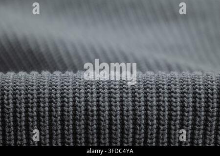 Gray knitted fabric showing ribbed texture and soft wool material details Stock Photo