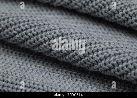 Grey knitted wool fabric showcasing warm, cozy texture for textile backgrounds Stock Photo