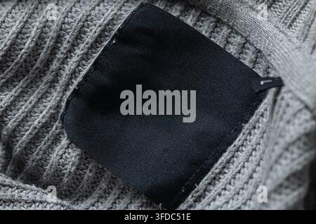 Empty black label creating a mock-up on a warm woolen textile background Stock Photo