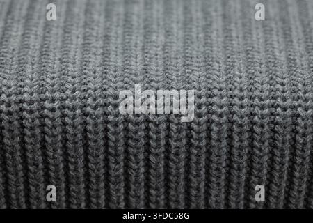 Gray knitted wool fabric showing a close-up texture background Stock Photo