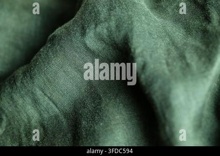 Wrinkled dark green fabric showing soft folds and natural texture Stock Photo