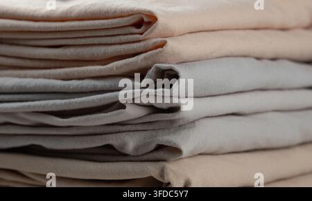 Stacked soft cotton linen fabric showing natural beige and grey tones Stock Photo
