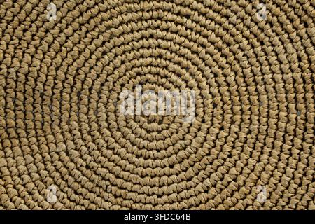 Circular pattern of natural woven straw creating an intricate background texture Stock Photo