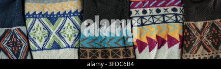 Knitted wool fabric showing a variety of vibrant geometric and ethnic patterns Stock Photo