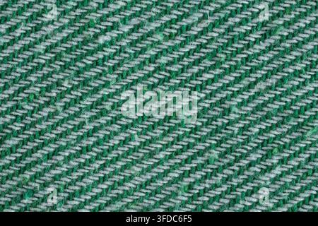 Green and white threads forming a textured diagonal pattern on woven textile material Stock Photo