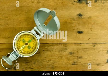 One compass on wooden table, space for text. Tourist equipment Stock Photo