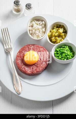 Tasty beef tartare prepared with fresh, healthy ingredients. Flavorful tartare made from fresh wholesome ingredients. Stock Photo