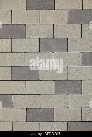 Regular shape paving blocks, texture, background. Paving slabs of grey cement blocks. Pavement with staggered laying. Reconstruction of paving road Stock Photo