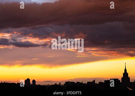 Dramatic Urban Sunset with Colorful Clouds over a City Skyline Stock Photo