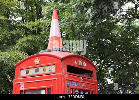 Infamous traffic cone on top of red phone box in Edinburgh, Scotland, UK. Stock Photo