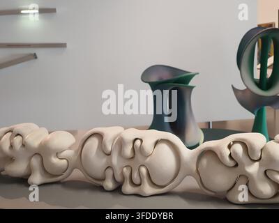 Close-up view of an abstract white sculptural artwork featuring organic, flowing forms with interconnected bulbous shapes and curved indentations, Stock Photo