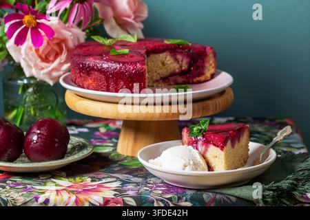 Plum Cake Served with Vanilla Ice Cream and Fresh Plums Stock Photo