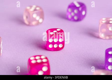 Different game dices on lilac background Stock Photo