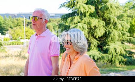Senior couple enjoying happy walking outdoors together Stock Photo