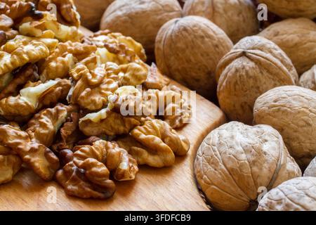 Walnuts and walnut kernels close-up. Composition of nuts. Selective focus. Stock Photo