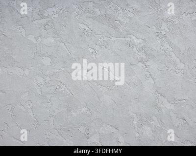 Gray textured concrete wall surface featuring rough stucco and plaster, creating a industrial backdrop Stock Photo
