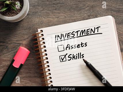Notebook showing investment checklist with skills checked, symbolizing choosing skills over assets. Investing in skills concept. Stock Photo