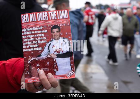 Liverpool, England, UK – A vendor holds up the Liverpool FC football fanzine Red All Over The Land outside Anfield stadium before a match. Stock Photo