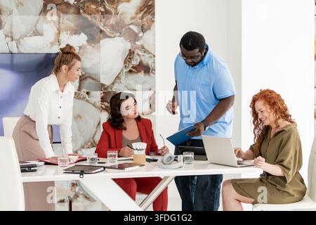 Diverse colleagues collaborating in a bright modern office Stock Photo