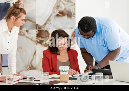 Diverse business team collaborating on a project together Stock Photo