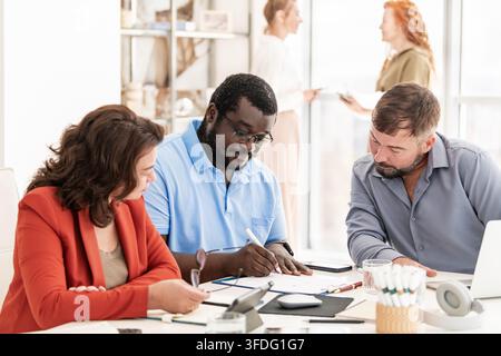 Diverse colleagues collaborating in an office meeting Stock Photo