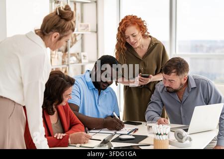 Diverse business team collaborating in office meeting Stock Photo