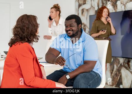 Friendly black man smiling during a business consultation Stock Photo