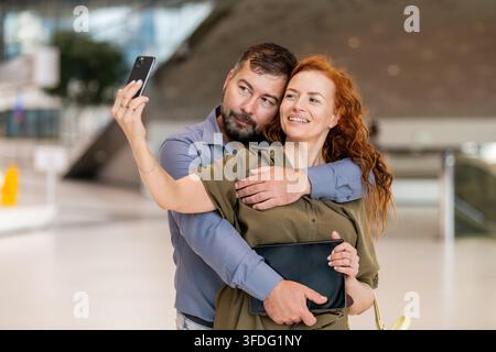 Smiling middle aged couple taking a selfie Stock Photo