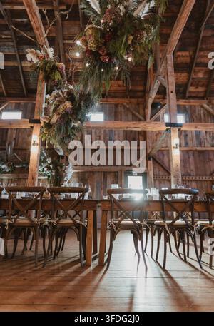 Rustic barn wedding reception with long tables Stock Photo