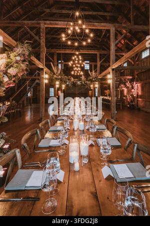 Long rustic dining table set for a wedding Stock Photo