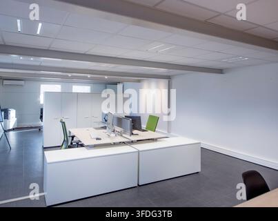 Contemporary open plan office with minimalist furniture and computer workstations Stock Photo
