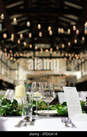Elegant wedding reception table setting with greenery Stock Photo