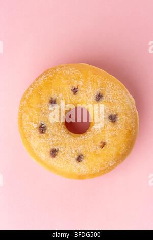 An elevated view of a Nutella Ring Donut on a pink background Stock Photo
