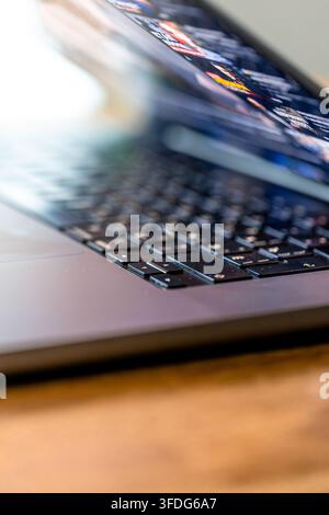 Laptop keyboard and blurred screen detail. Vertical technology scene with copy space. Stock Photo