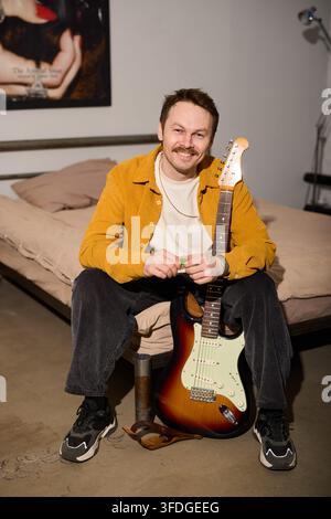 Caucasian man session guitarist preparing for recording Stock Photo
