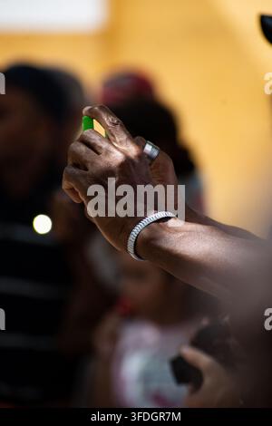 Close Up of Person's Hands Holding Smartphone to Record During El Carnavalito Event in Ciego de Ávila, Cuba - August 21, 2026 Stock Photo