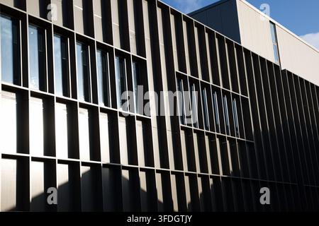 Detail of the striking vertical louvres and geometric window patterns on the exterior facade of The Hub in Radcliffe, Lancs, UK. Stock Photo