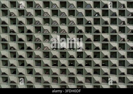 Seamless style full frame texture of a modern olive green breeze block wall featuring uniform geometric roster pattern for ventilation. Stock Photo