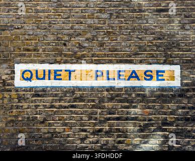 Painted Quiet Please sign on a weathered brick wall in Chelsea, London, England, UK. Stock Photo