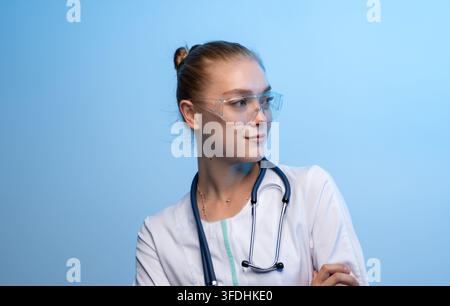 Young female medical professional wearing protective goggles Stock Photo