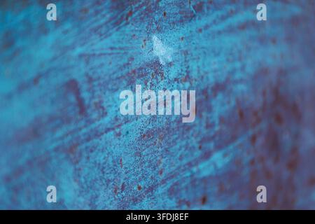 An abstract photographic background featuring a weathered and rusted metal surface in turquoise and blue tones with a shallow depth of field, creating Stock Photo