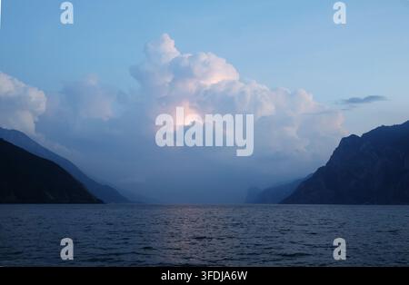 Dramatic storm clouds with lightning over Lake Garda, viewed from Torbole, Trentino, Italy. Stock Photo