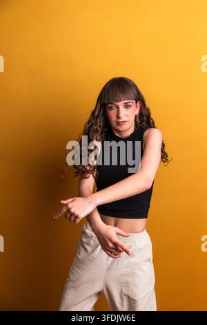 Young woman dancing with energy and expressive movement Stock Photo