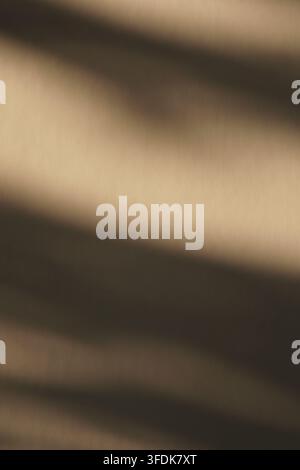 Elegant abstract image featuring soft diagonal shadows on a warm beige textured background. Stock Photo