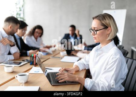 Businesswoman Using Laptop On Corporate Meeting Working Sitting In Office Stock Photo
