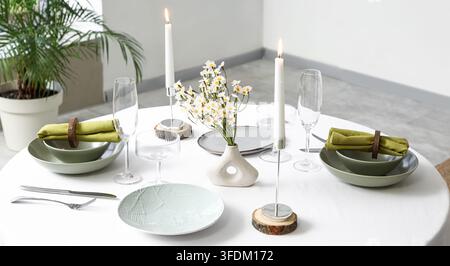 Fine dining and hospitality concept, elegant table setting with candles and wildflowers for romantic dinner or event catering in a modern restaurant Stock Photo